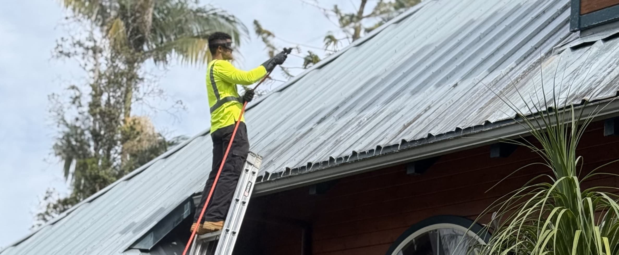 Roof soft washing service on Big Island Hawaii using a safe low-pressure cleaning process